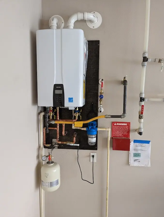 Professional plumber installing copper piping in a Binghamton home